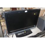 An Hitachi flat screen television with remote cont