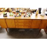 A teak long sideboard fitted three central drawers