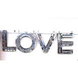 A silvered "Love" sign