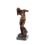 A bronze abstract figure of a naked girl on green