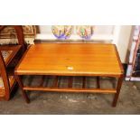 A teak Danish coffee table, raised on square secti