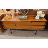 A G-plan design six drawer sideboard, raised on ro