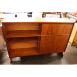 A teak low wall unit, having drop flap drinks comp