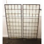 A pair of vintage metal framed window panels, 123cm x 49cm