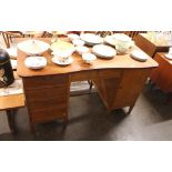 A Danish teak pedestal desk, fitted drawers and cu