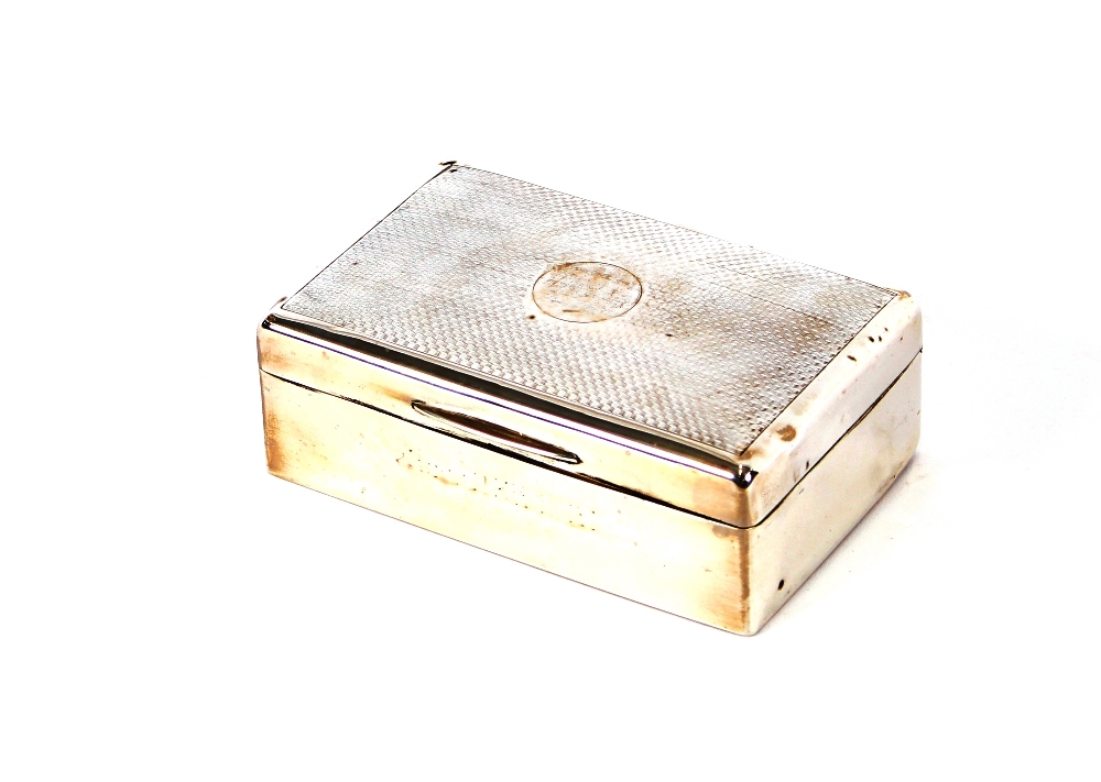 A silver cigarette box, engine turned decoration a