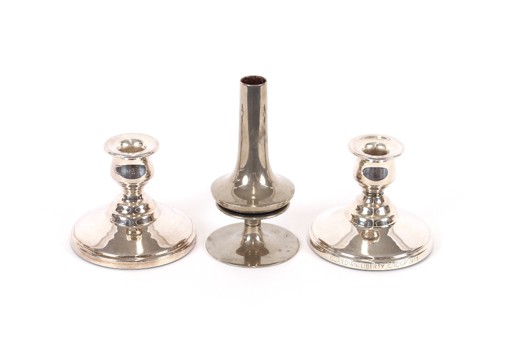 A pair of plated dwarf candlesticks inscribed Guar