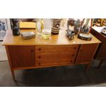 A teak sideboard fitted three central drawers flan
