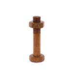 An unusual modernist olive wood pepper mill in the