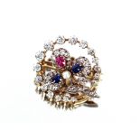 A diamond, sapphire and ruby set brooch with flowe