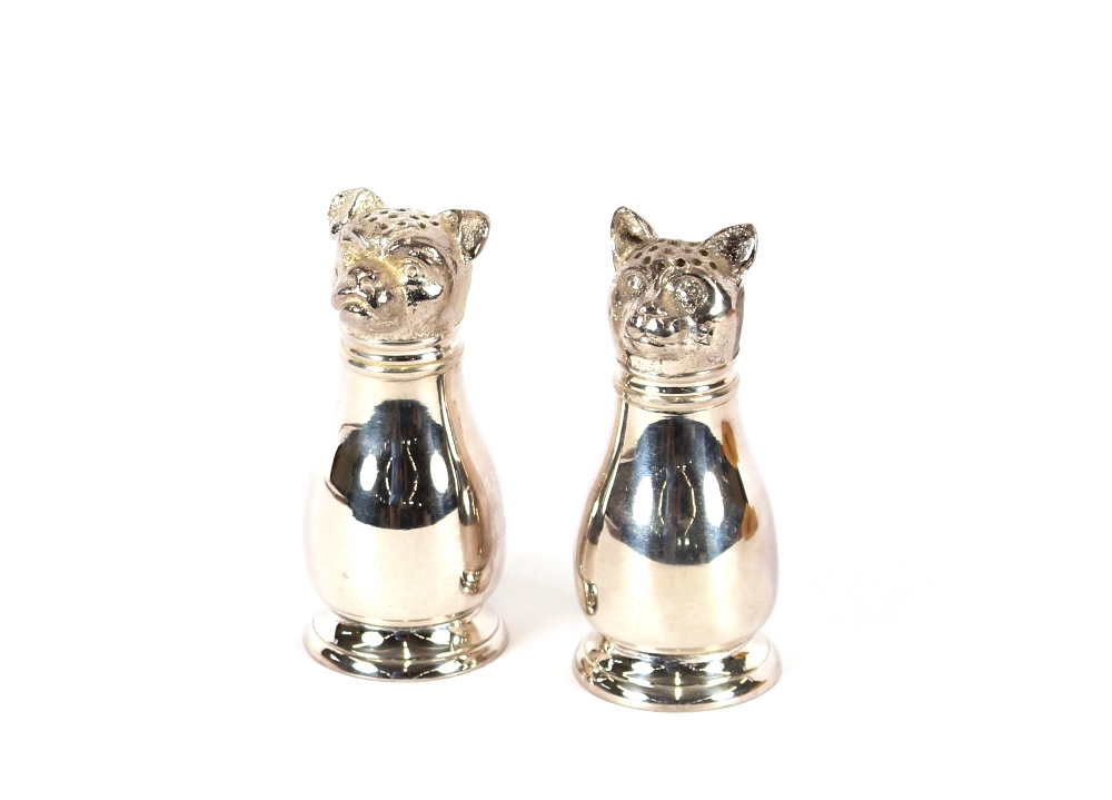 A pair of silver plated dog salt and pepper pots