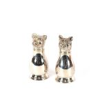 A pair of silver plated dog salt and pepper pots
