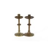 A pair of Arts & Crafts style brass candlesticks