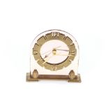 An Art Deco design mirrored and brass mantel clock