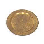A large circular Eastern brass tray with embossed