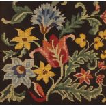 A 20th Century woolwork embroidery depicting flowe
