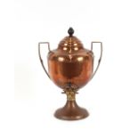 An antique copper samovar having brass handles and