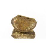 A gilt metal snuff box in the form of a nut