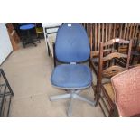 A blue upholstered swivel office chair