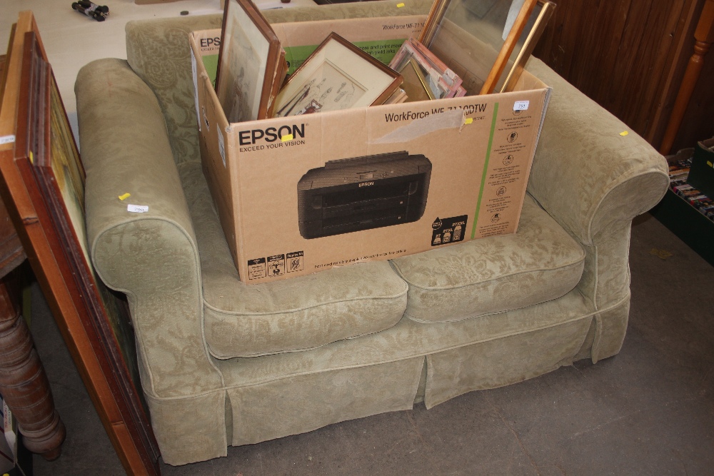 A green upholstered two seater settee