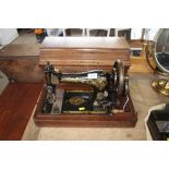 A Singer hand sewing machine in fitted case