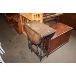 A small oak drop leaf table raised on barley twist