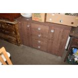 An oak effect sideboard fitted four drawers