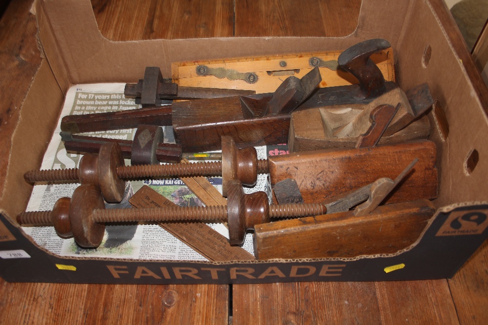 A box of various vintage carpentry tools to include wood working planes