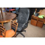 A black upholstered swivel office chair