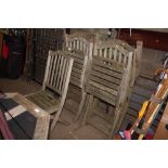 A set of five teak folding garden chairs