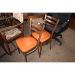 A pair of ladder back dining chairs