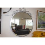 A metal framed circular mirror