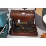 A Singer hand sewing machine in carrying case