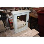 A mirror fronted bathroom cabinet