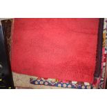 An approximate 6'5" x 4'5" red wool rug