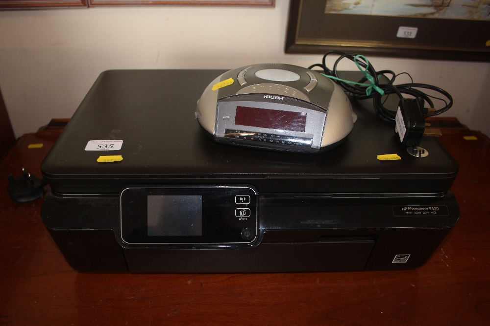 A Bush radio alarm clock; together with an HP phot