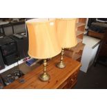 A pair of brass table lamps and shades