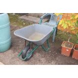 A plastic and metal wheel barrow; and a garden cha