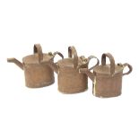 Three antique brass water cans