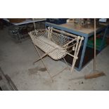 A Victorian wrought iron folding cot and a wooden