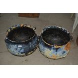 A pair of iron cauldrons