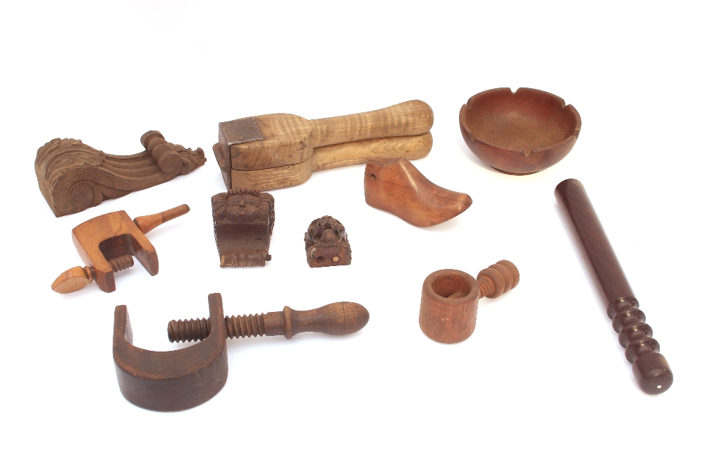 A wooden tray containing various treen items inclu