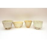 Four various white china jelly moulds