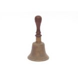 A hand bell with turned wooden handle