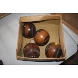 Four Lignum Vitae bowling woods and a jack