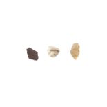 Three early flint arrowheads contained in a mahoga