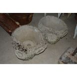 A pair of concrete rustic style garden planters