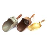 Three vintage grain scoops, one copper, one brass