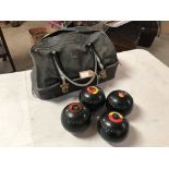 Four bowling woods in a carrying bag