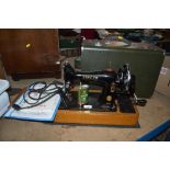 A vintage Singer sewing machine with original case